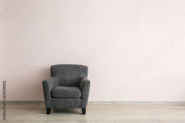 Fototapeta Comfortable armchair near light wall