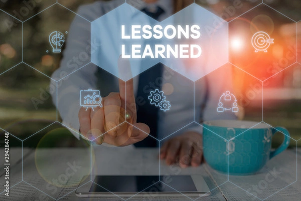Obraz Word writing text Lessons Learned. Business photo showcasing the knowledge or understanding gained by experience Woman wear formal work suit presenting presentation using smart device