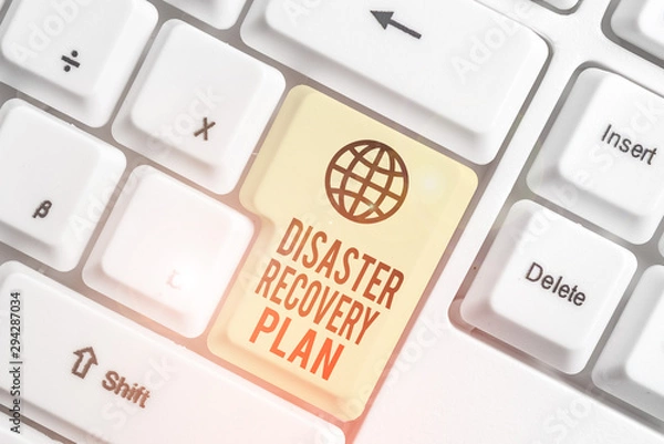 Obraz Writing note showing Disaster Recovery Plan. Business concept for having backup measures against dangerous situation White pc keyboard with note paper above the white background