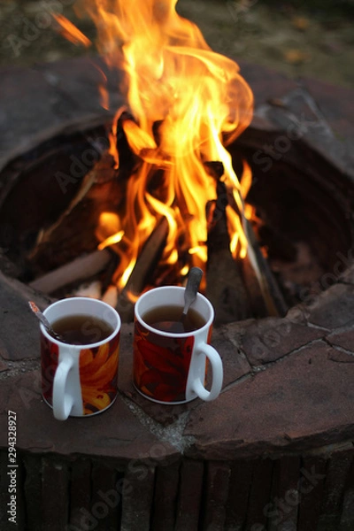 Fototapeta Cups of tea by the fire
