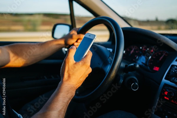 Obraz Man using phone while driving