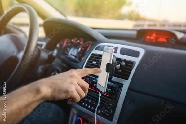 Fototapeta Man using phone while driving