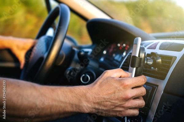 Fototapeta Man using phone while driving