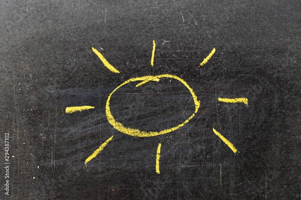 Fototapeta Yellow color chalk hand drawing in sun with ray shape on blackboard background