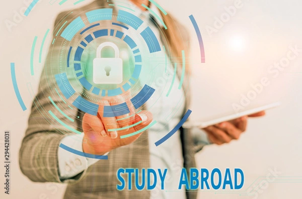 Fototapeta Word writing text Study Abroad. Business photo showcasing live in a foreign country and attend a foreign university Female human wear formal work suit presenting presentation use smart device