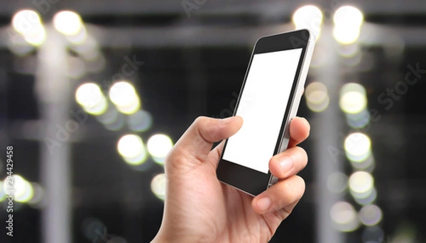 Fototapeta Man hand holding smartphone device touching screen