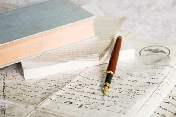 Obraz fountain pen on old blank papers in front of books