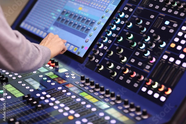 Fototapeta operator working with stage lighting console