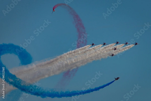 Obraz Jet planes fly in formation with colored smoke trails