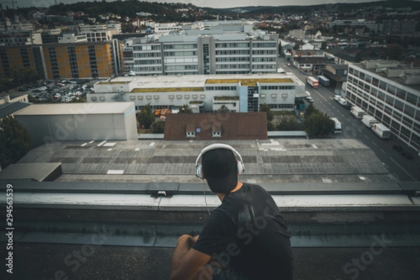 Fototapeta Man on a roof top of an abandoned building