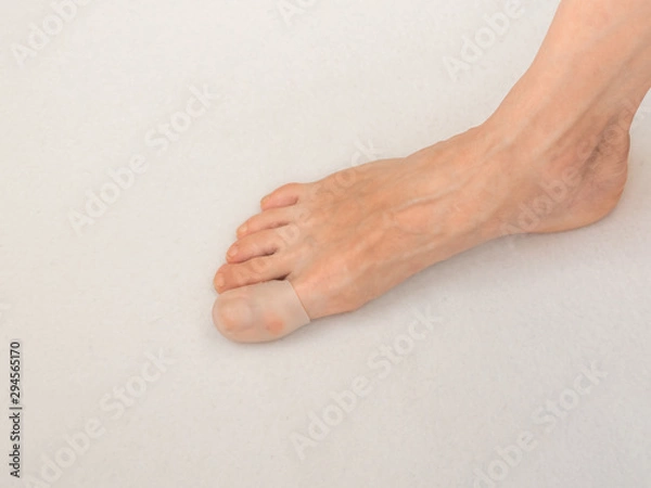 Fototapeta The fingertip is protective from calluses on feet. Protection from corns.