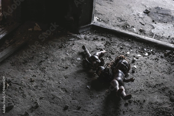 Fototapeta abandoned and scary baby dolls on ground, post apocalyptic concept