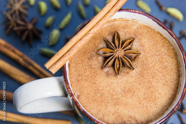 Obraz Chai Tea In Mug With Star Anise & Cinnamon Bark With More Ingredients In Background Including Green Cardamon & Whole Cloves
