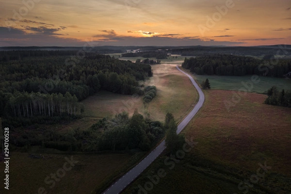 Fototapeta Aerial view of foggy rural fields at sunset