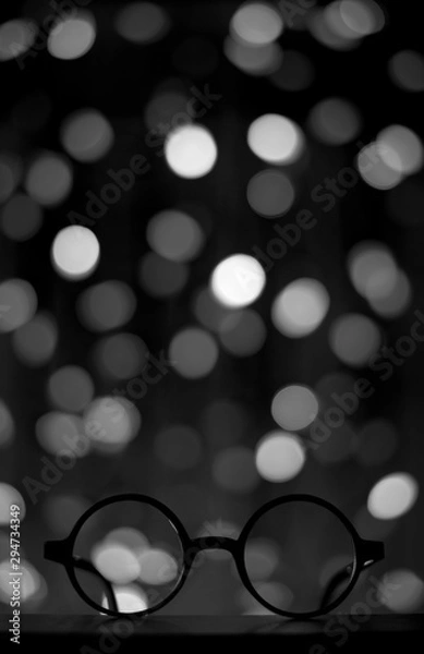 Obraz harry potter glasses in dark space with bright lights in the background, copyspace, copy space, wizard themed birthday party invitation