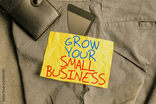 Fototapeta Writing note showing Grow Your Small Business. Business concept for company generates positive cash flow Earn Smartphone device inside trousers front pocket with wallet