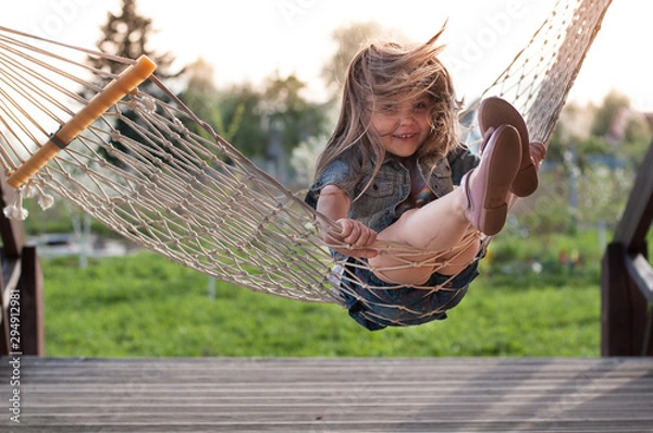 Fototapeta Laughing child having fun on swing