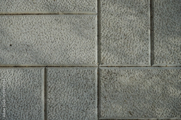 Fototapeta The texture of cement floor tiles. Rough surface with particles of sand and debris.