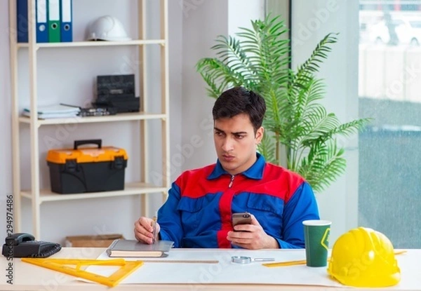 Fototapeta Foreman looking at construction plan