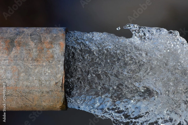 Fototapeta Old and rusty pipe with flow out water.