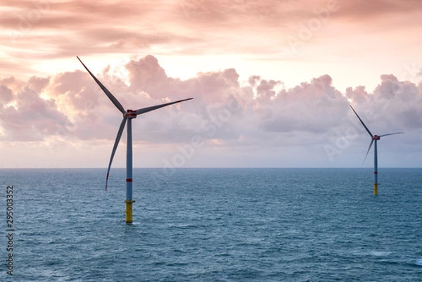 Obraz Sunset over offshore wind farm - green power generation