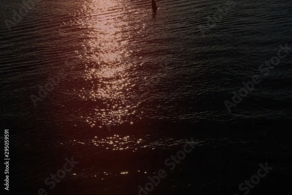 Fototapeta red reflection of sun in water