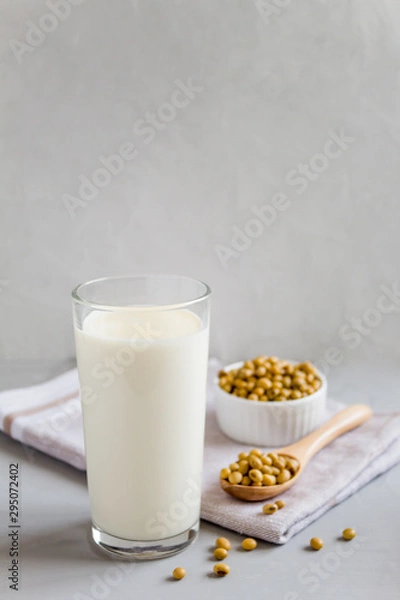 Obraz Soy milk in a glass and beans in a plate. The concept of healthy eating. Vegetarian food. Vegetable drink. Copy space, side view.