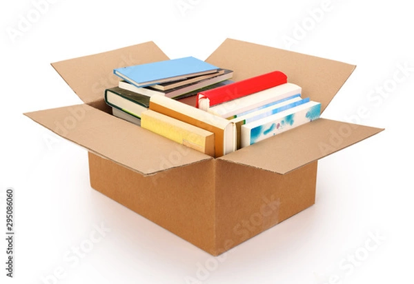 Fototapeta Moving house cardboard box filled with books, isolated on white background. Contains clipping path.