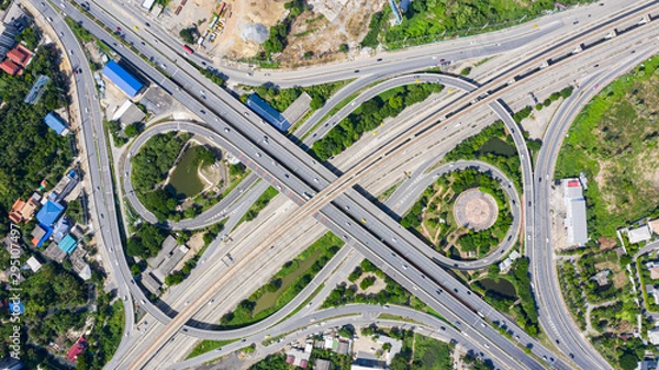 Fototapeta Rail track and conductor rail  top view, Road Expressway traffic an important infrastructure with moving cars and railway tracks on which the train rides in Bangkok Thailand.