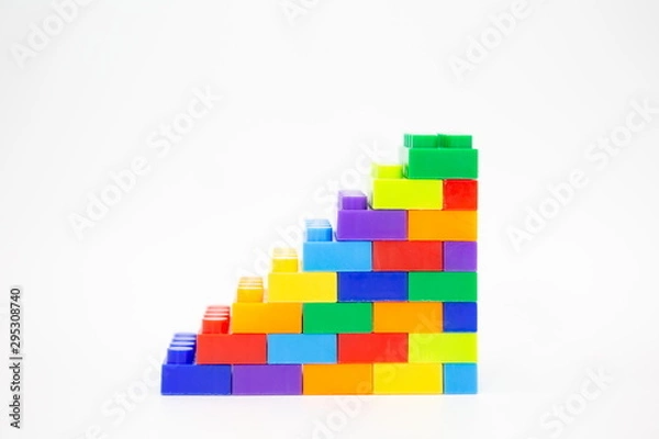 Fototapeta brick blocks stairs cube toy mini figures colorful on white background . building plastic fun collection for child .
