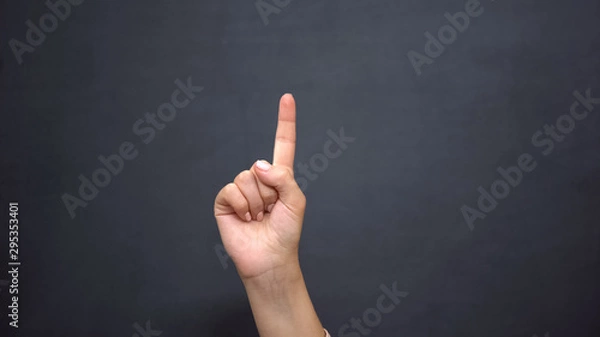 Fototapeta Hand pointing finger up, gesturing attention, announcement of ideas, advertise