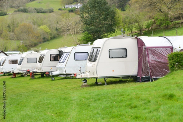 Fototapeta Touring caravans lined up on their pitches on a caravan site in rural Wales.