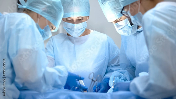 Fototapeta Surgical operating team performing thoracic surgery in modern hospital, health