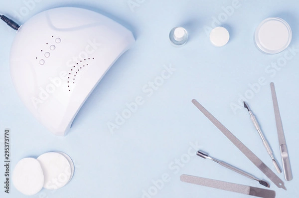 Fototapeta Bubbles with varnish on an insulated surface with LED lamp and a set of tools for nail extensions