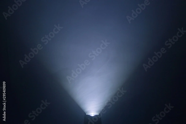 Obraz flashlight and light beam in dark mist room at night . abstract projector spotlight white lay growing .