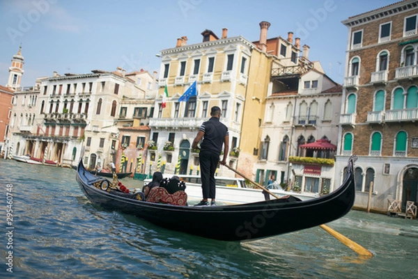 Fototapeta Venice / Italy - September 29th 2019: Gondolier rowing a gondola in Grand Canal