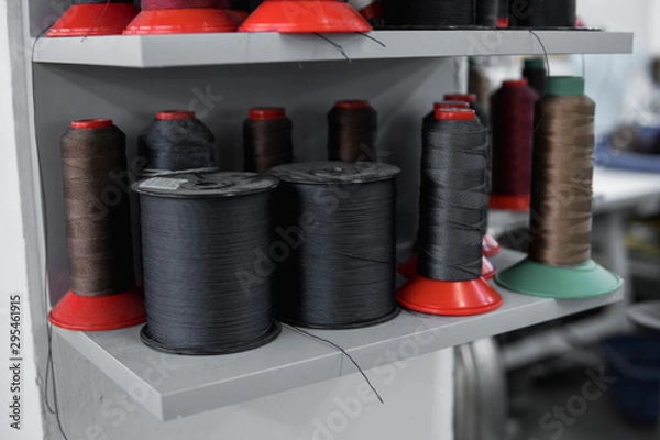 Fototapeta A lot of spools of thread for sewing clothes and shoes.