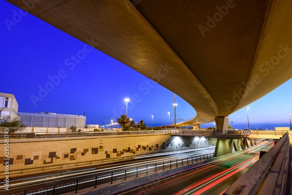 Obraz Beautiful light trails of fast-moving traffic at the blue hour in Bahrain