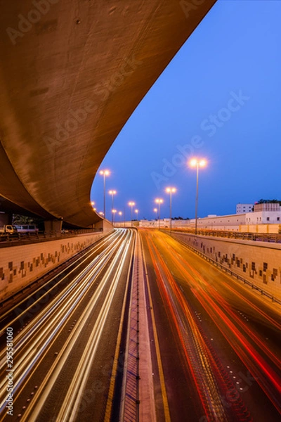 Obraz Beautiful light trails of fast-moving traffic at the blue hour in Bahrain