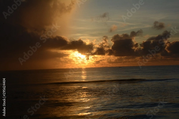 Obraz Sunrise over the sea on a partly cloudy dawn