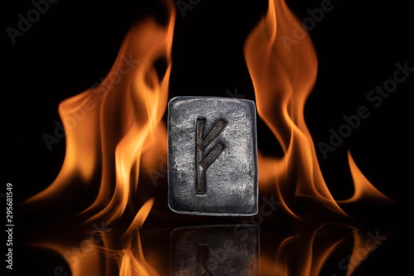 Fototapeta Norse rune Fehu. Wealth, creativity, passion, fire. Rune Fehu is associated with the Scandinavian goddess Freya. The rune is isolated in the background of the flames.