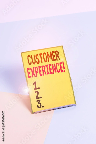 Fototapeta Word writing text Customer Experience. Business photo showcasing product of interaction between organization and buyer Paper placed tilted above buffer wire on soft pastel multi colours backdrop