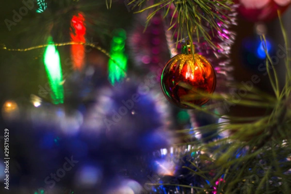 Obraz Christmas tree decorated with toys and a garland. New year background for your design. Seasonal holidays in winter