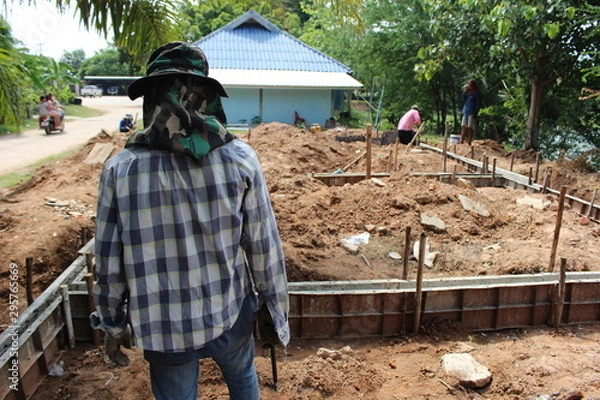 Fototapeta The controller was walking around the construction site of the house