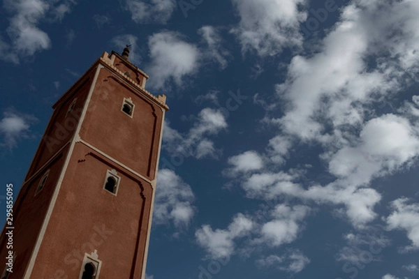 Obraz Moroccan square minaret taken from below with beautiful blue sky and clouds