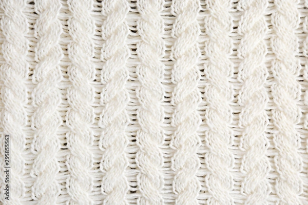 Fototapeta Cropped close up shot of seamless woolen knitting pattern of fall / winter season warm sweater, clearly visible fiber texture of stylish hipster knitwear clothing. Background, copy space, top view.