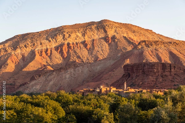 Obraz Moroccan berber village with mountains, river, desert, mountains and lush vegetation near sunrise