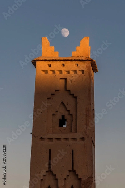 Obraz Moroccan village tower with moon framing the top spires