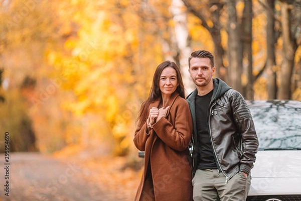 Fototapeta Happy family walking in autumn park on sunny fall day