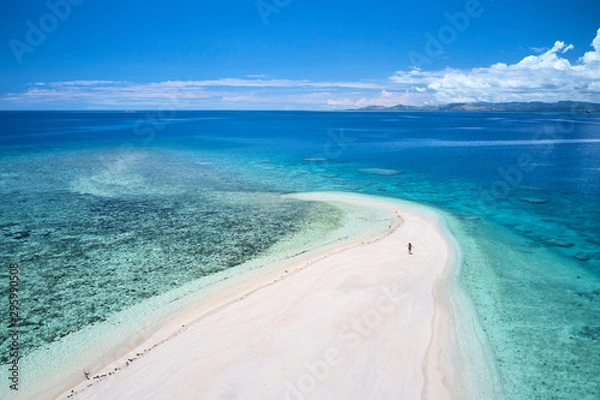 Obraz Woman on remote island in Fiji overlooking blue coral reef	